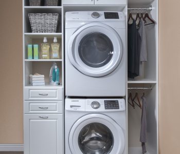 White cabinet laundry room organizational system with shelving.