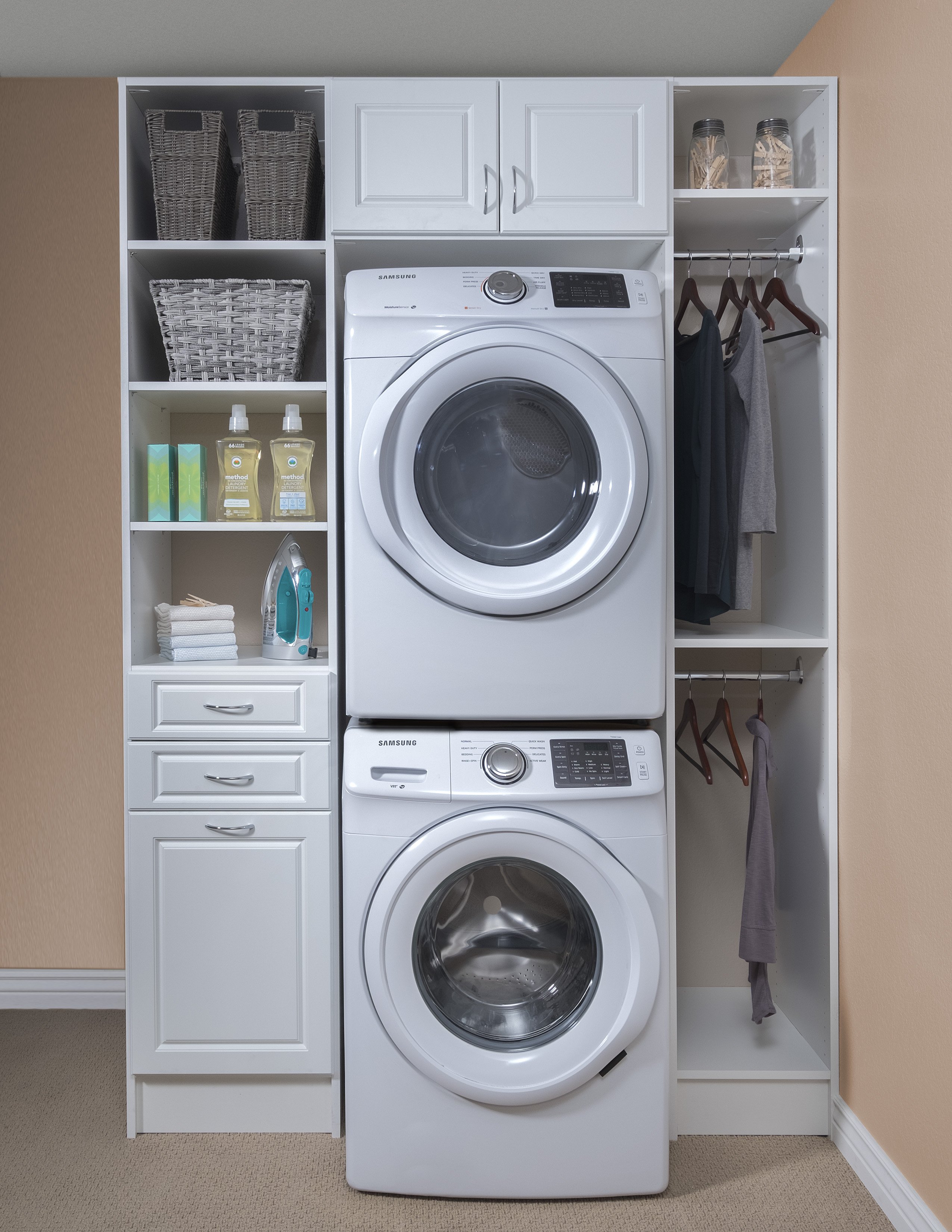 White cabinet laundry room organizational system with shelving.
